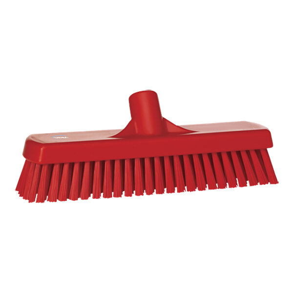 A red Vikan wall / floor scrub head with stiff bristles and a handle.