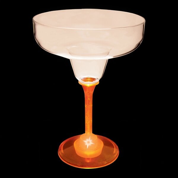 A clear plastic margarita glass with an orange LED light inside.