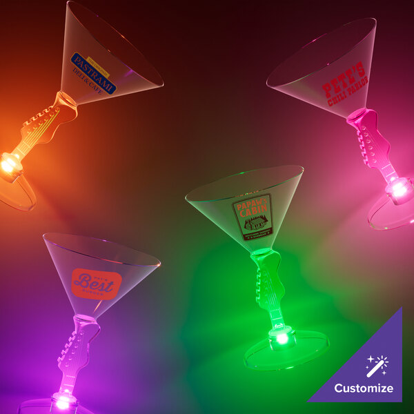 A group of 7 oz. customizable plastic martini glasses with guitar stems and green LED lights.