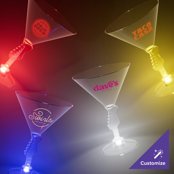 A group of Customizable Plastic Guitar Stem Martini glasses with red LED lights on a table.