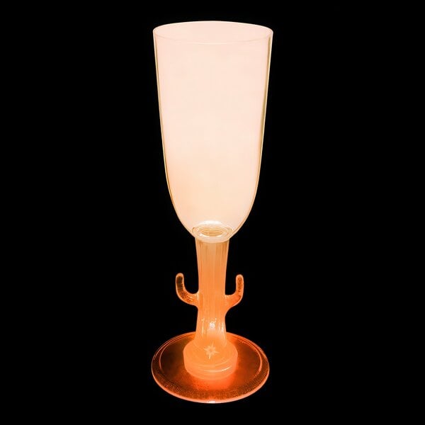 A close up of a customizable plastic cactus stem champagne cup with an orange LED light.