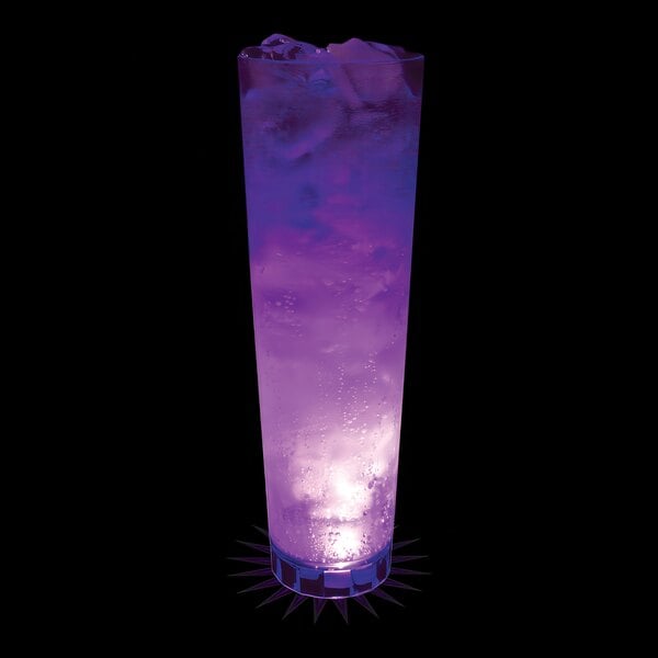 A 32 oz. customizable plastic cup with a purple LED light filled with a purple drink with ice cubes.
