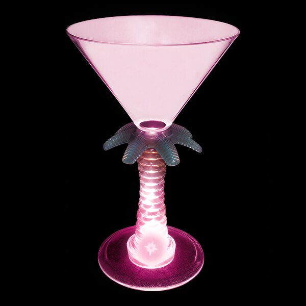 A pink plastic martini glass with a palm tree stem and base with a pink LED light.