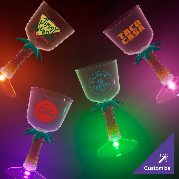 A group of 7 oz. plastic wine cups with pink LED lights and palm tree stems.