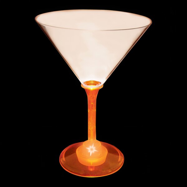 A close up of a 10 oz. plastic martini glass with an orange LED light inside it.