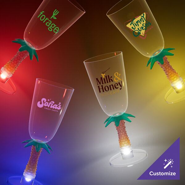 A close-up of a customizable plastic palm tree stem champagne cup with a yellow LED light.