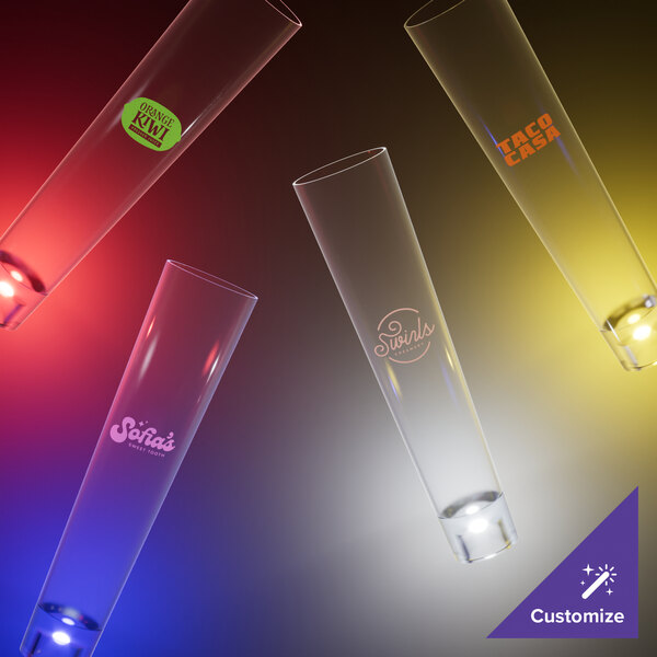 A group of 7 oz. plastic champagne shooters with yellow LED lights.