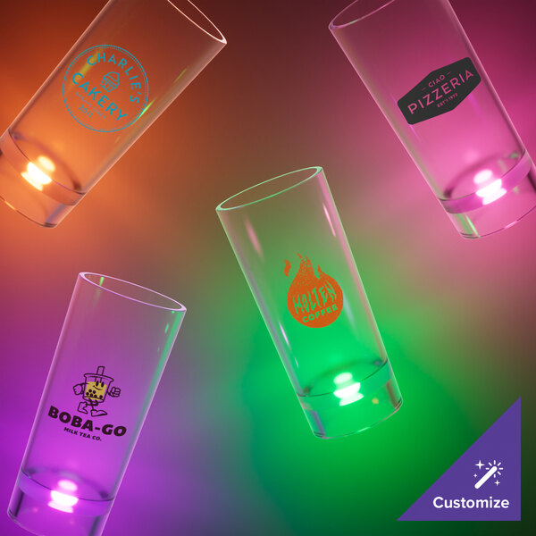 A close-up of a customizable plastic champagne shooter with an orange LED light.