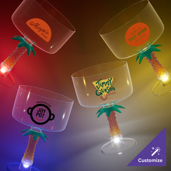 A group of 18 oz. plastic margarita cups with palm tree stems and blue LED lights.