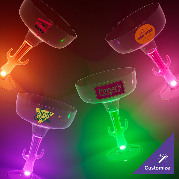 A group of 3 plastic cactus stem margarita cups with LED lights in the stems.