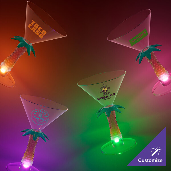 Three customizable plastic palm tree stem martini glasses with green LED lights.