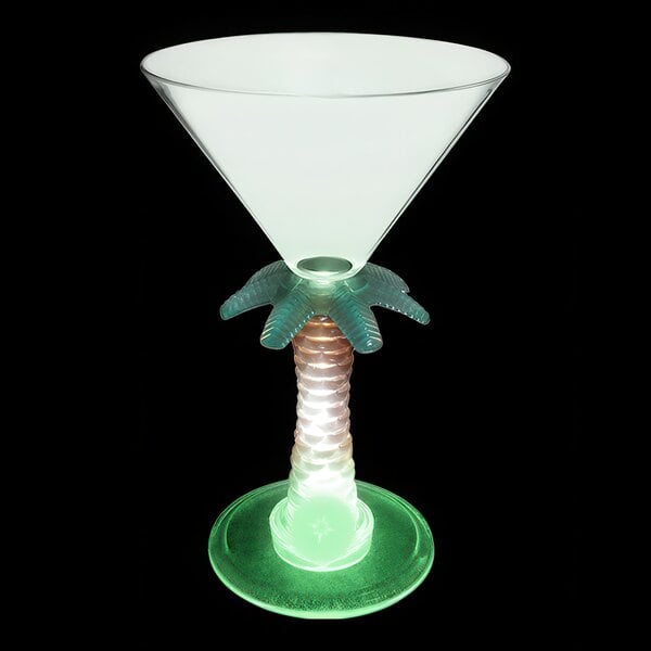 A white plastic martini glass with a green palm tree stem and a green LED light.