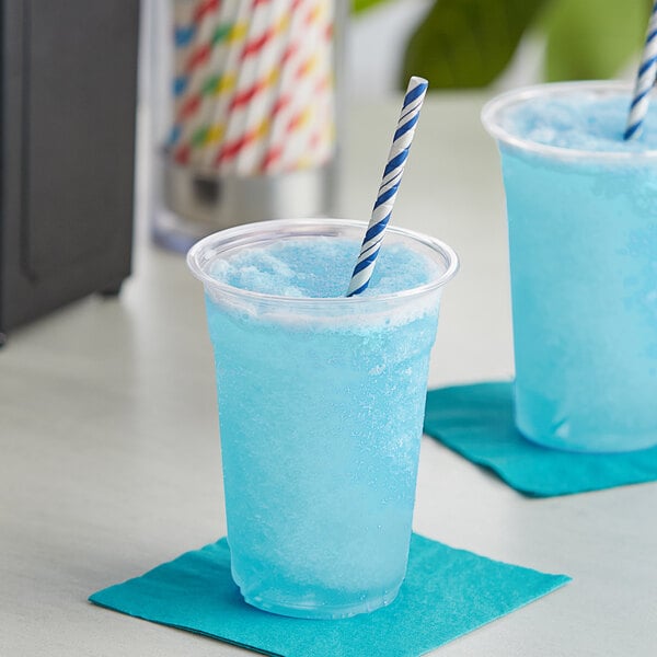 blue raspberry slushy in a cup with a straw