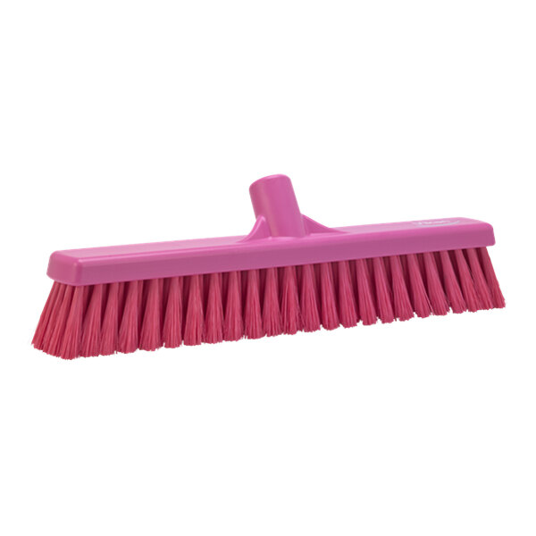 A close-up of a Vikan pink broom head with flagged bristles.