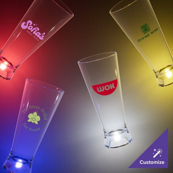 A group of customizable clear plastic pilsner cups with yellow LED lights.