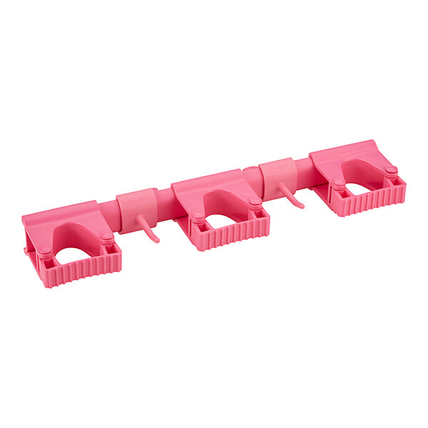 A pink plastic Vikan wall bracket hook.