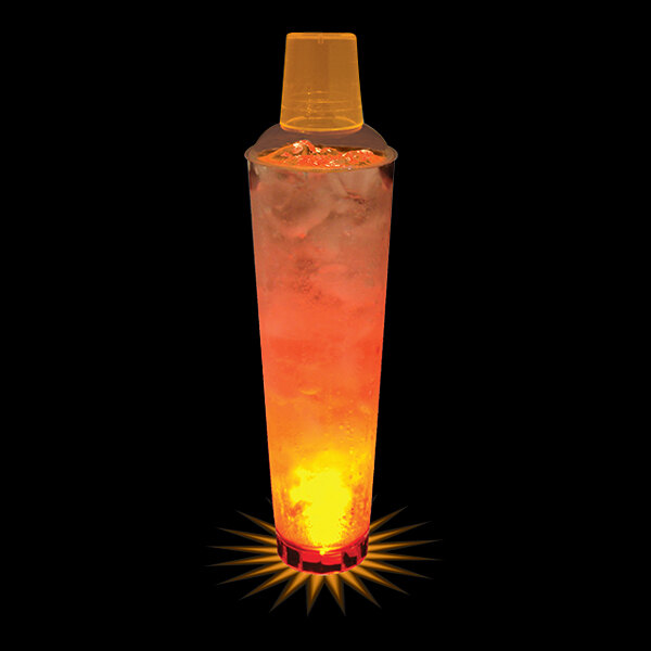 A close up of a 32 oz. plastic shaker cup filled with glowing orange liquid.