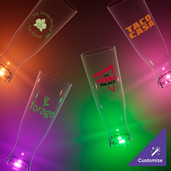 A close-up of a tall 22 oz. plastic pilsner cup with an orange LED light and a logo on it.