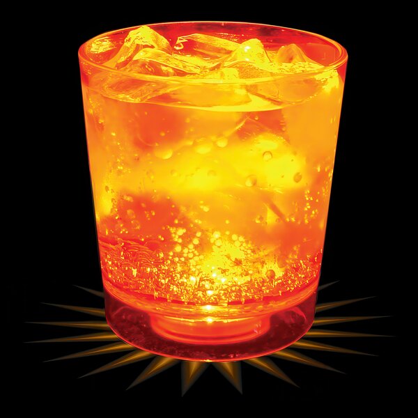 A customizable plastic rocks cup with orange liquid, ice, and an orange LED light.