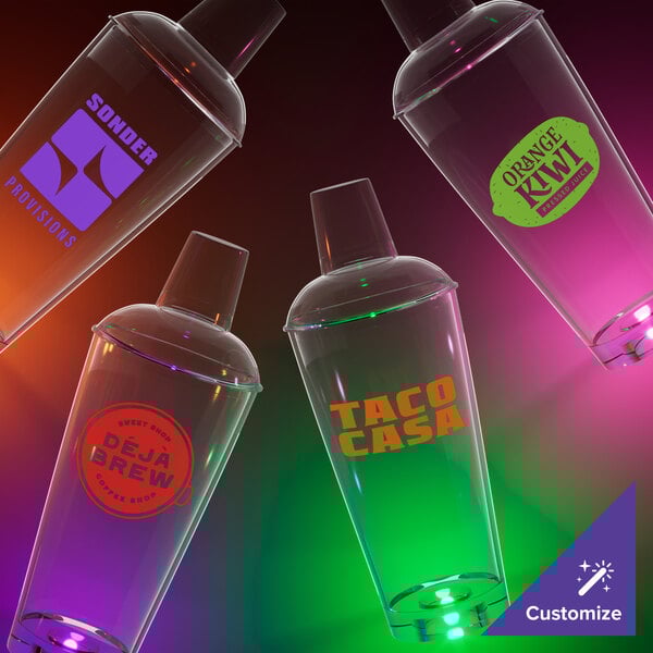 A close-up of a green plastic cocktail shaker with a green LED light inside.