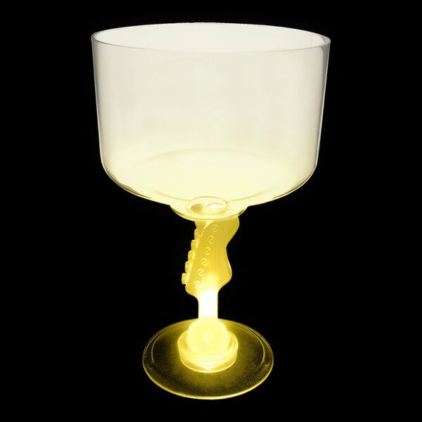 A clear plastic margarita glass with a yellow LED light on the stem.