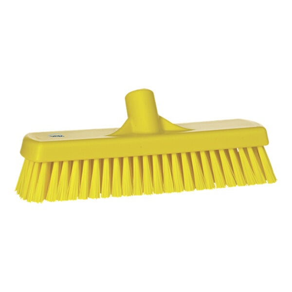 A close-up of a yellow Vikan 70606 Wall / Floor Scrub Head with stiff bristles.