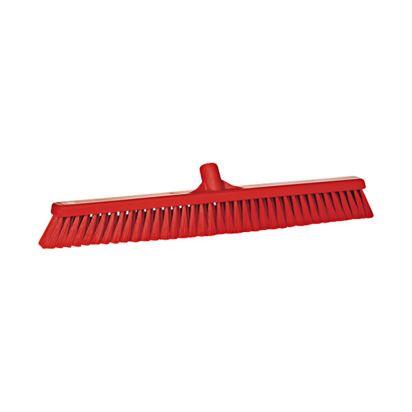 A red broom head with flagged bristles.