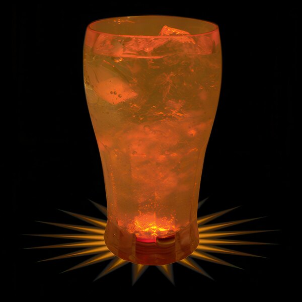 A customizable plastic soda cup with orange LED light inside filled with orange liquid and ice.