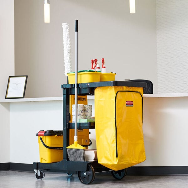 A janitor cart with shelves and a yellow vinyl zippered bag, equipped with cleaning supplies and tools.
