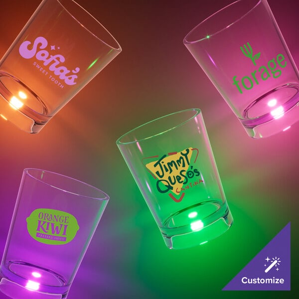 A close-up of a customizable plastic shot cup with a green LED light.