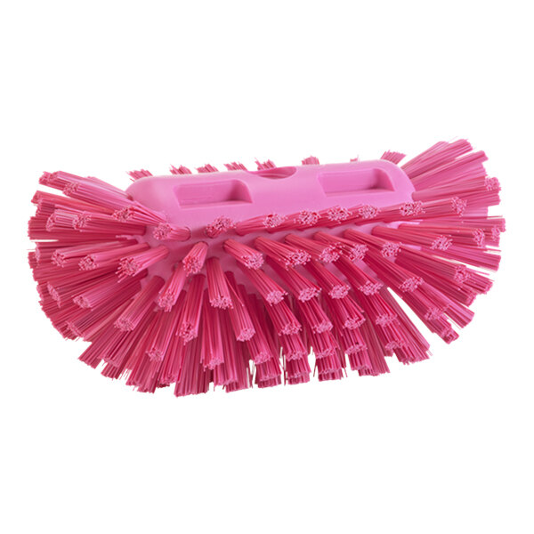 A close-up of a Vikan pink tank brush head with stiff bristles.