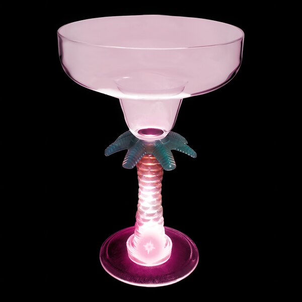 A clear plastic margarita glass with a palm tree stem and pink LED light.