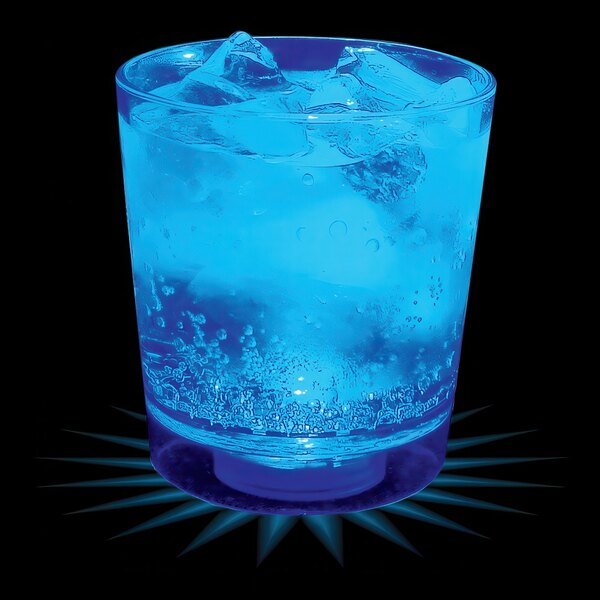 A blue drink in a customizable plastic rocks cup with blue LED light and ice.