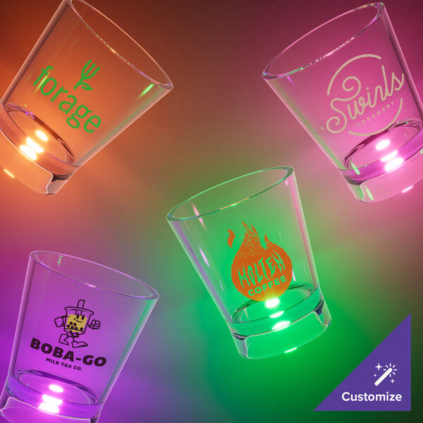 A close-up of a customizable plastic shot cup with a purple LED light.