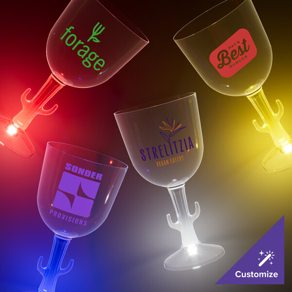 A close-up of a customizable plastic cactus stem wine glass with a yellow LED light.