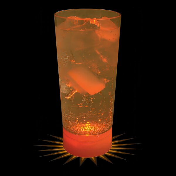 A 10 oz. customizable plastic cup with orange LED light filled with orange liquid and ice cubes.