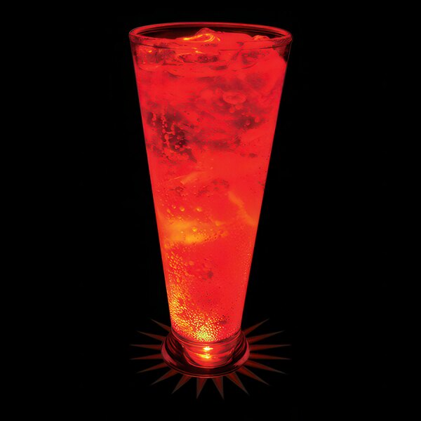 A customizable plastic pilsner cup with a red drink inside and a red LED light on it.