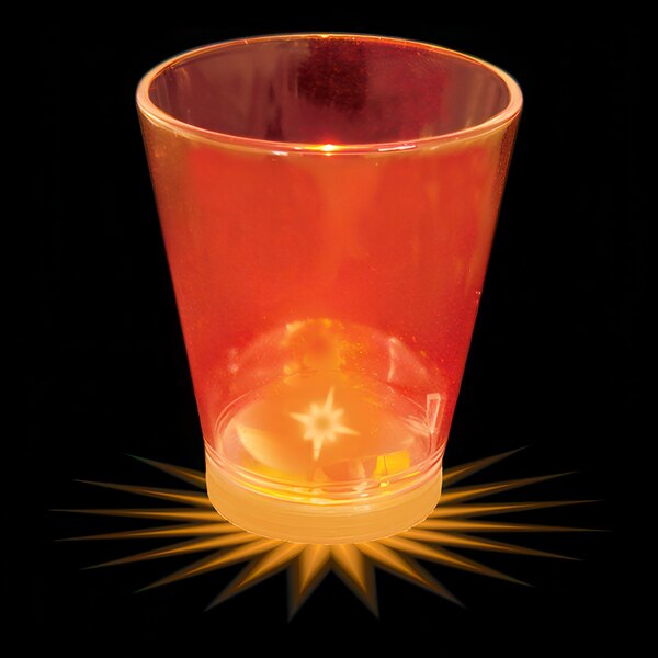 A customizable plastic shot cup with an orange LED light on a counter.