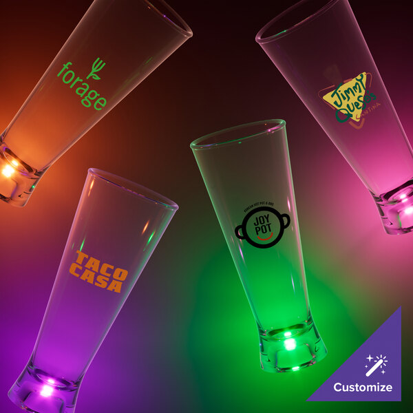 A group of 16 oz. customizable plastic pilsner cups with green LED lights.