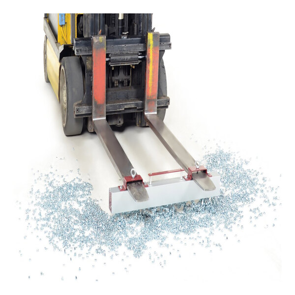 A forklift with a Vestil steel magnetic sweeper attached to the forks.