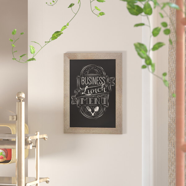 A Flash Furniture wall mount chalkboard with the words 'i love to laugh' written on it.