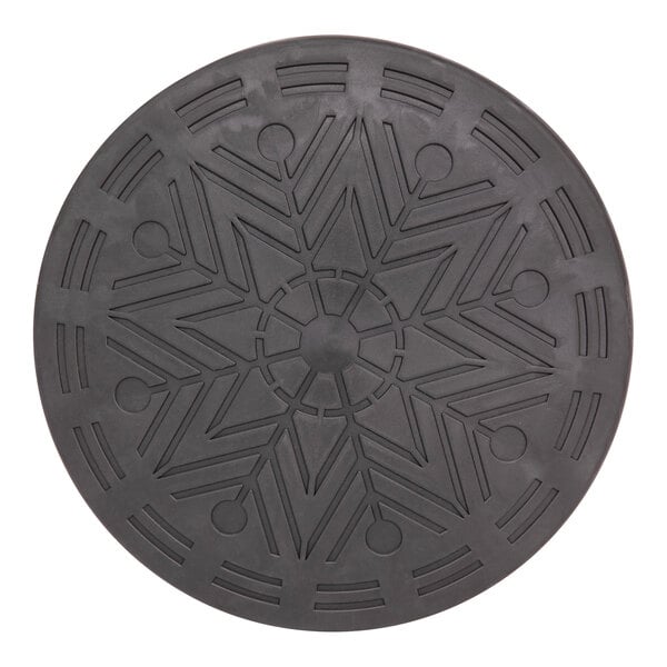 A blue circular object with a grey circular design on a surface.