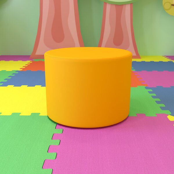 A yellow circle sits on a colorful surface.