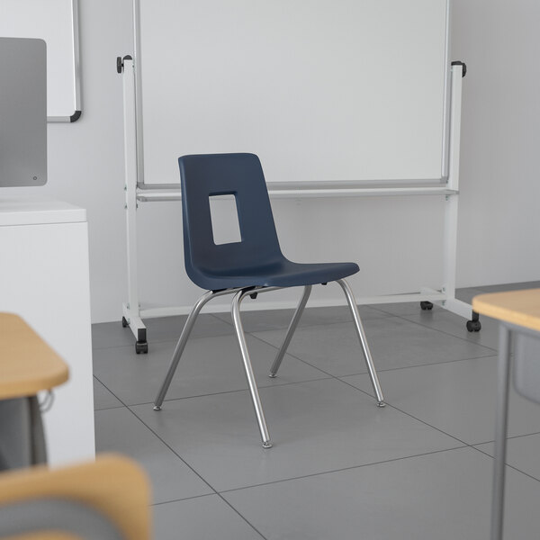 A navy blue Flash Furniture Mickey Advantage classroom chair with a square cut out on the back.