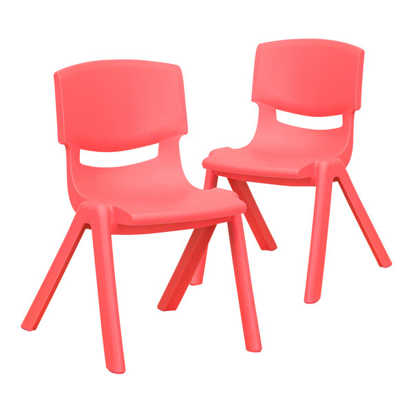 A pair of red plastic chairs with pink legs.