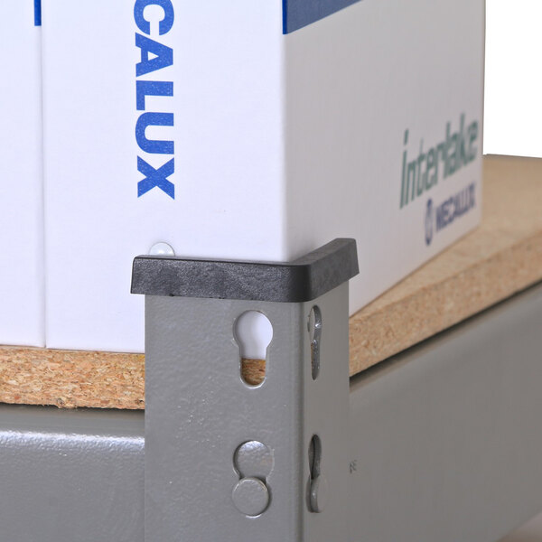 A white box with blue writing that reads "Interlake Mecalux" containing heavy-duty rivet shelving with wooden panels.