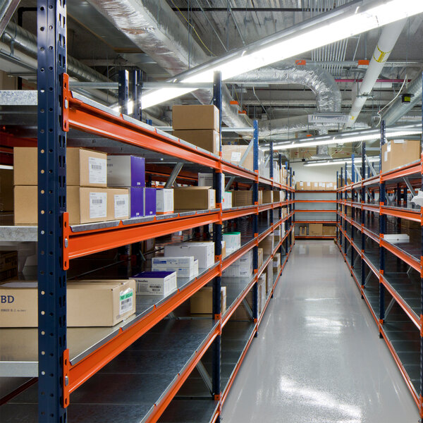 A blue Interlake Mecalux bulk rack with orange shelves holding boxes.