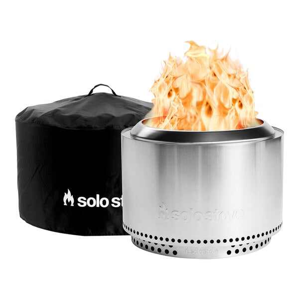 A Solo Stove fire pit with a black cover with white text.