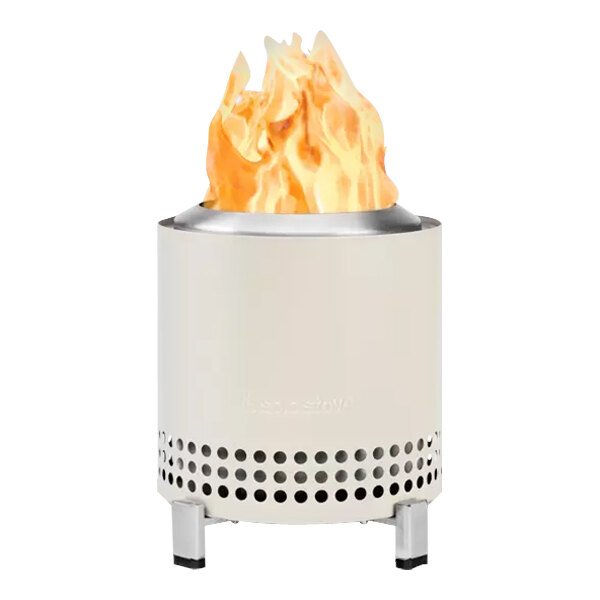 A white Solo Stove Mesa XL tabletop fire pit with a fire burning in it.