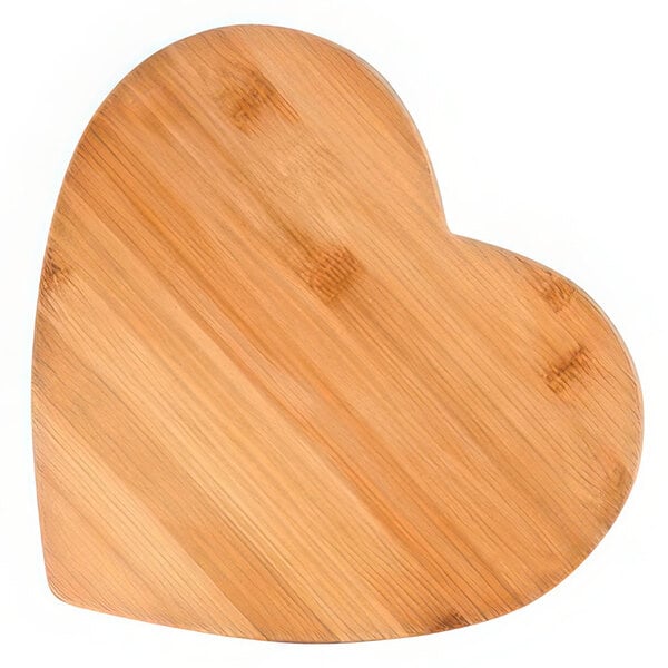 A Franmara heart-shaped bamboo cutting board on a table.